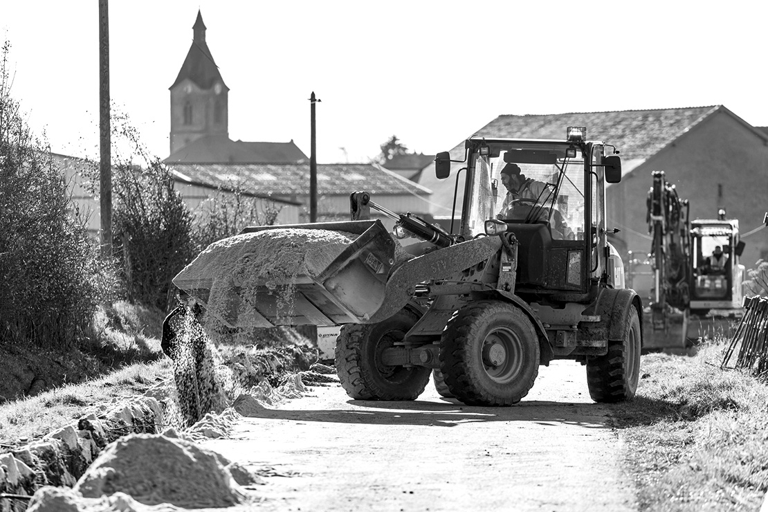 Bagger füllt ein Loch mit Sand